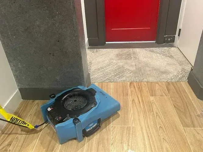 Air mover drying wood-look tile by a doorway, an example for La Palma homes