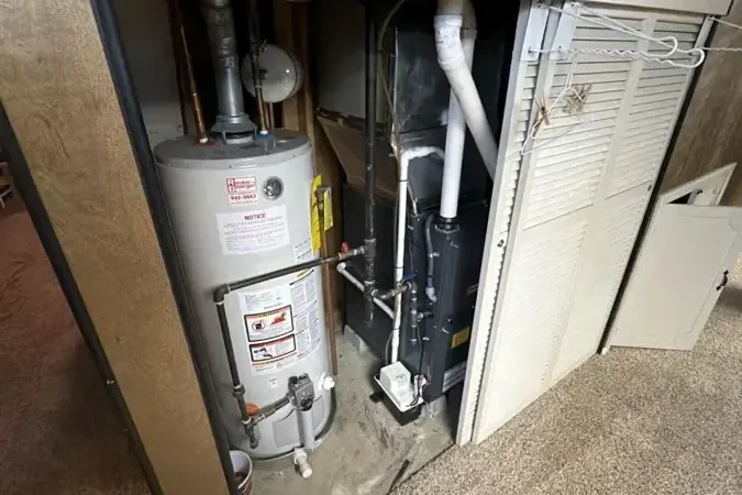 Water-stained closet around a leaking tank water heater